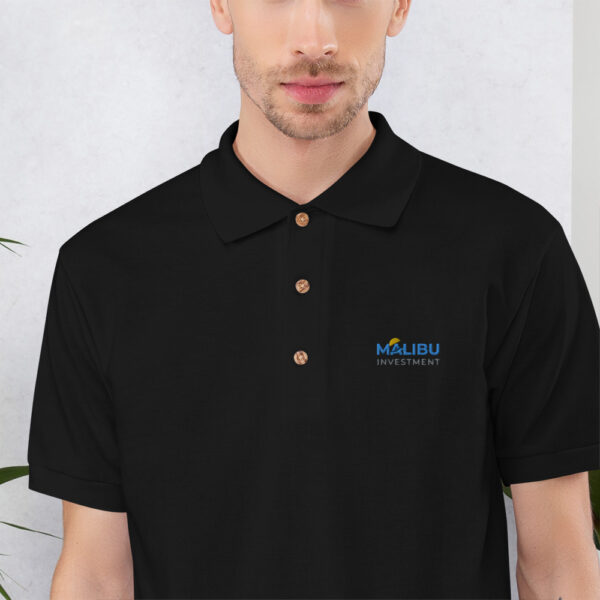 Black polo shirt with Malibu Investment logo.