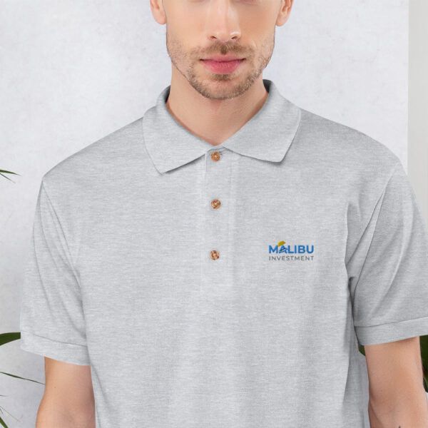 Malibu Investment logo on grey polo shirt.