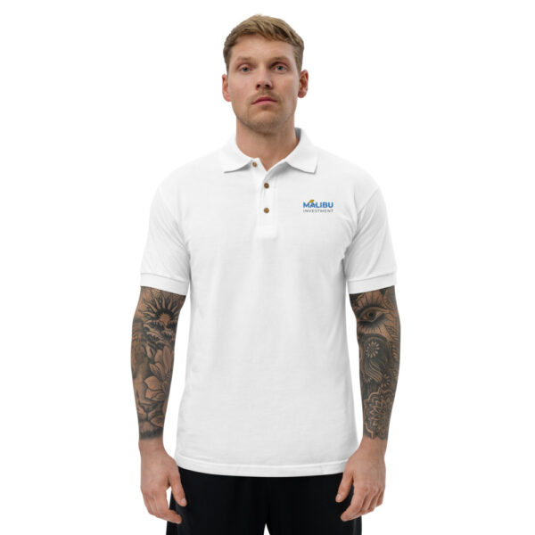 Man in Malibu Investment polo shirt.