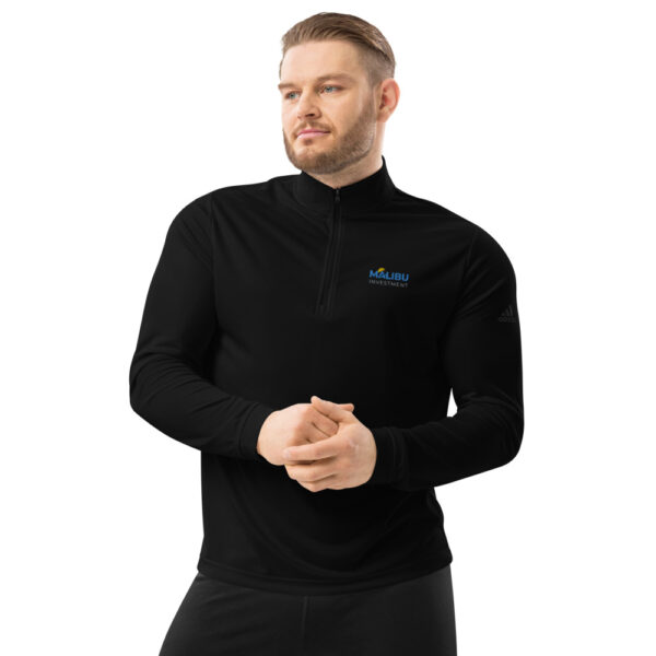 Man in black Malibu Investment quarter-zip.