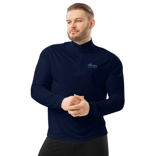 Man in navy Malibu Investment quarter-zip.