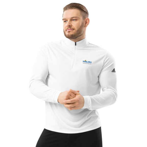 Man in white Adidas quarter-zip Malibu Investment logo.