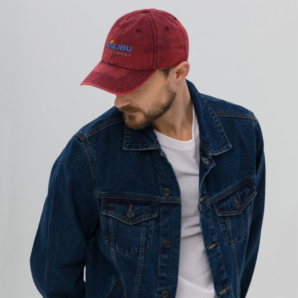 Man in denim jacket wearing Malibu Investment cap.