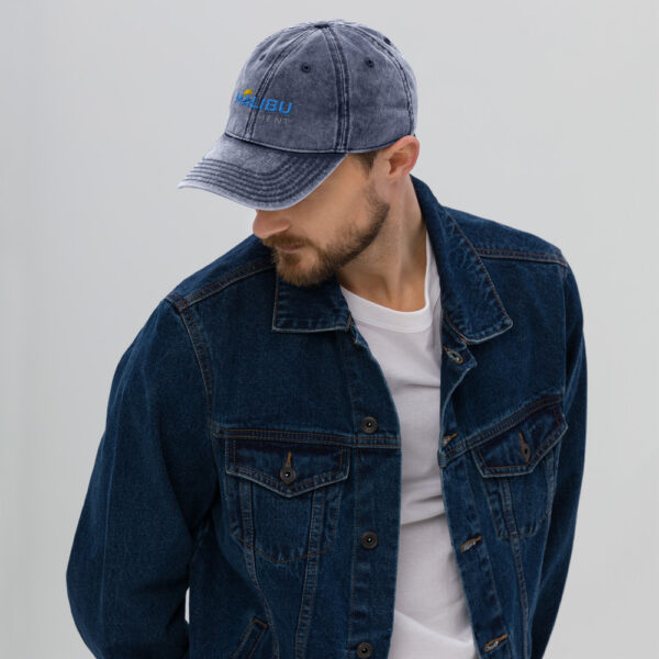 Man in denim jacket wearing Malibu cap.