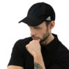 Man wearing black Adidas baseball cap.